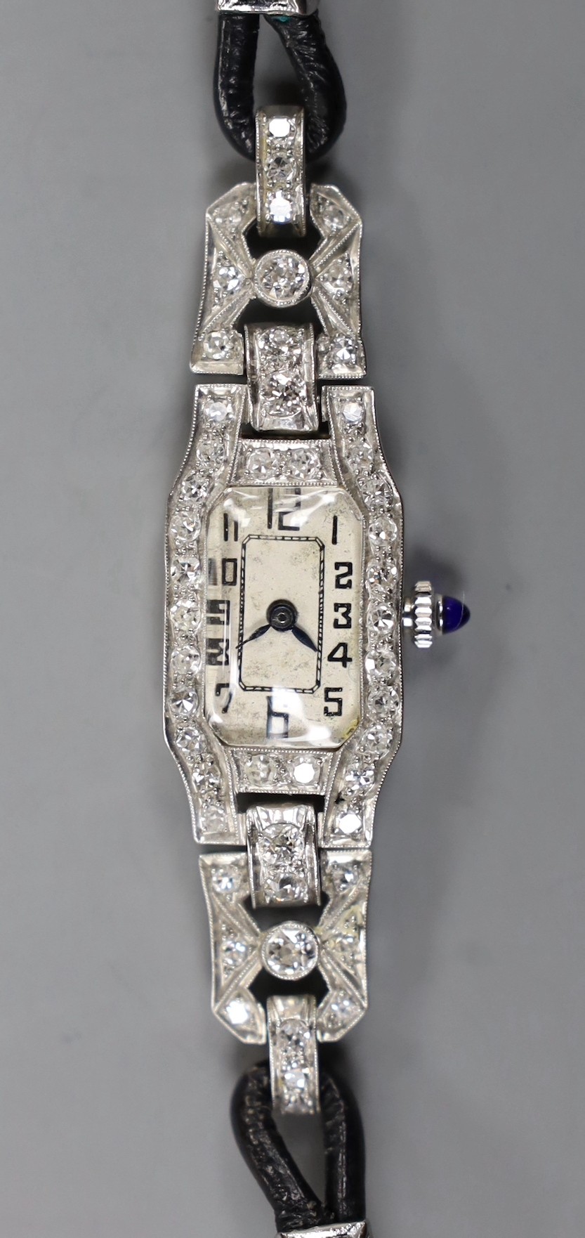 A lady's 1940's white metal (stamped plat) and diamond set manual wind cocktail watch, with Arabic dial, on fabric strap, gross weight 15.7 grams.